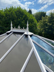 Conservatory with glass and solid roof panels