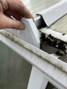 Replacement gutter bracket on an old conservatory roof
